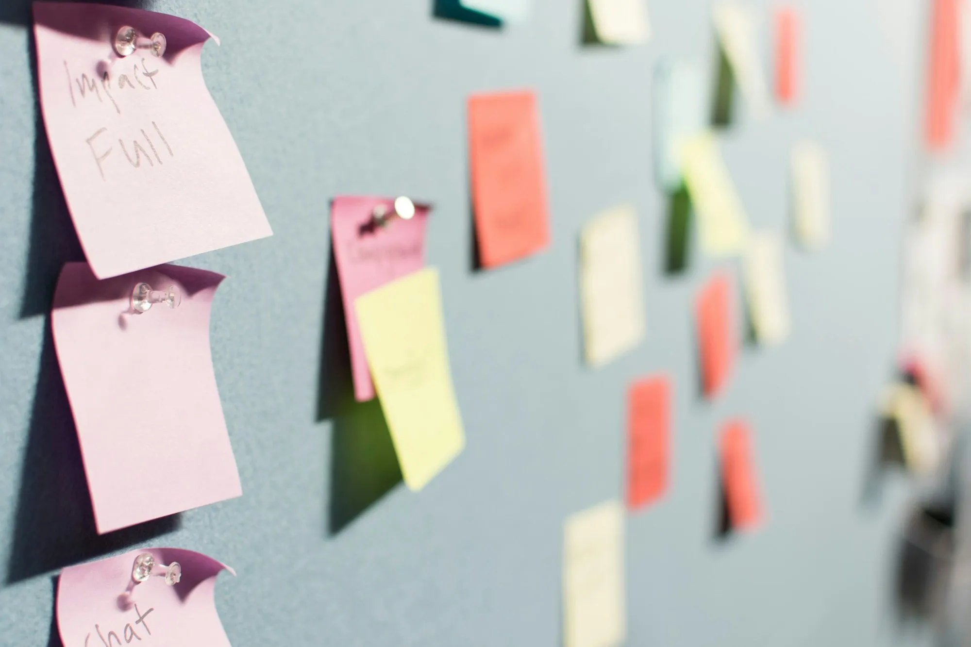 Colourful sticky notes pinned to a board after a brainstorming session