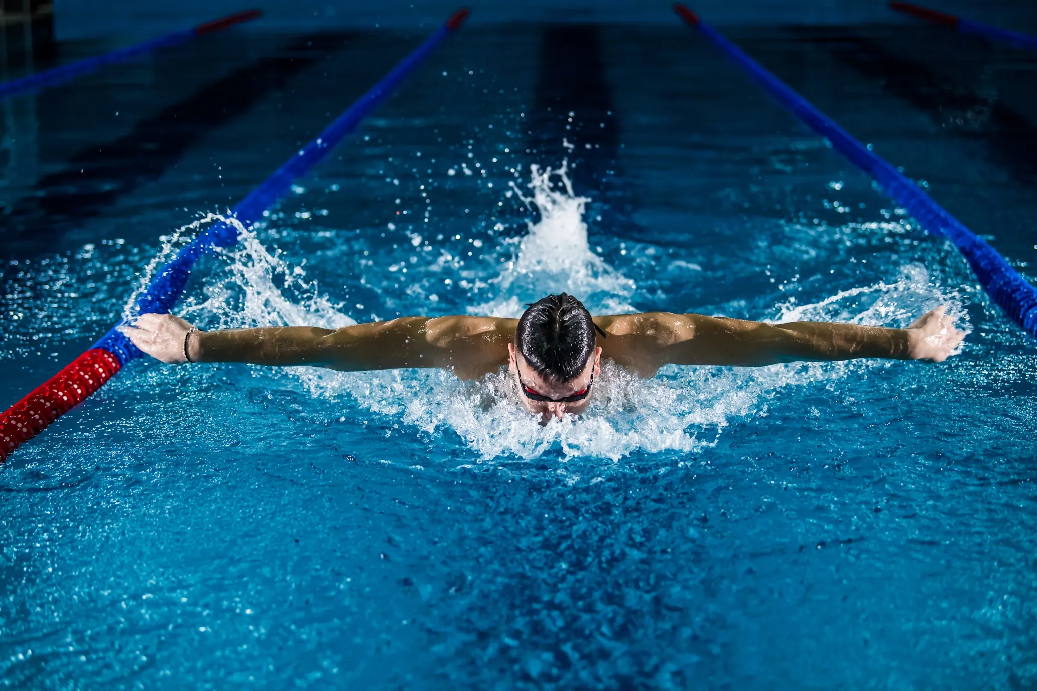 A swimmer doing the butterfly stroke in a pool